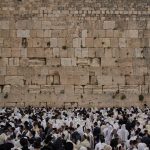 Covered in prayer shawls, Jewish men of the Cohanim Priestly caste participate in a blessing during the holiday of Passover, at the Western Wall, the holiest site where Jews can pray, in the Old City of Jerusalem, Tuesday, April 15, 2025. (AP Photo/Leo Co