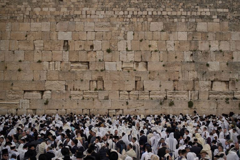 Covered in prayer shawls, Jewish men of the Cohanim Priestly caste participate in a blessing during the holiday of Passover, at the Western Wall, the holiest site where Jews can pray, in the Old City of Jerusalem, Tuesday, April 15, 2025. (AP Photo/Leo Co