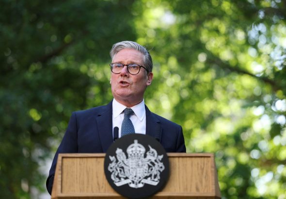 Britain's Prime Minister Keir Starmer speaks during a reception following the UK-EU summit, in London, Monday May 19, 2025. (Hannah McKay/Pool via AP)