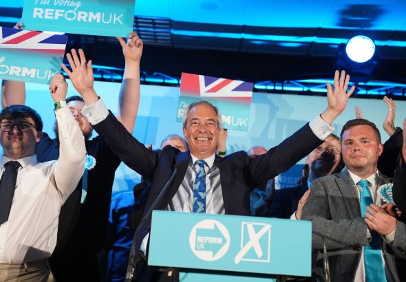 Reform UK party leader Nigel Farage with his party's candidates onstage during a campaign event at Stafford Showground, Stafford, whilst campaigning for this week's local elections. Picture date: Wednesday April 30, 2025.