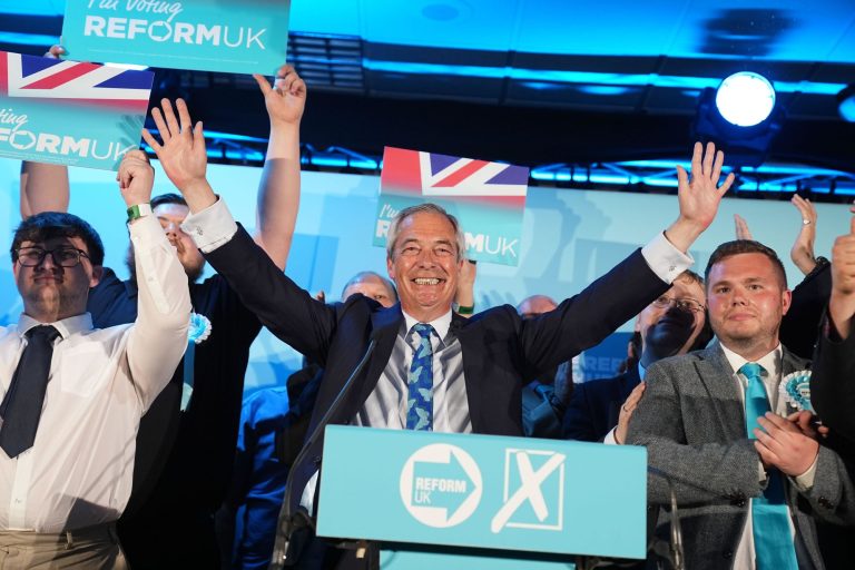 Reform UK party leader Nigel Farage with his party's candidates onstage during a campaign event at Stafford Showground, Stafford, whilst campaigning for this week's local elections. Picture date: Wednesday April 30, 2025.