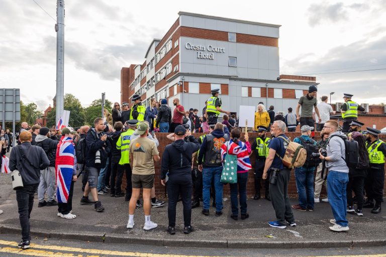 Altrincham, UK. 27 JUL, 2025. Police try to keep both Pro and Anti Migrant protestors seperate as both sides gathered outside the Cresta Court Hotel, which is believed to be housing migrants, as the wave of anti migrant protest against hotels continues ac